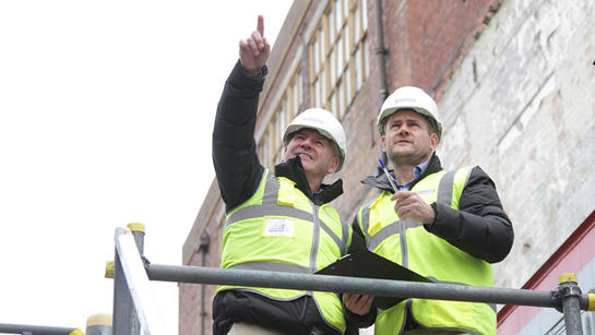 Two Team Members On Building Site Two Team Members On Building Site